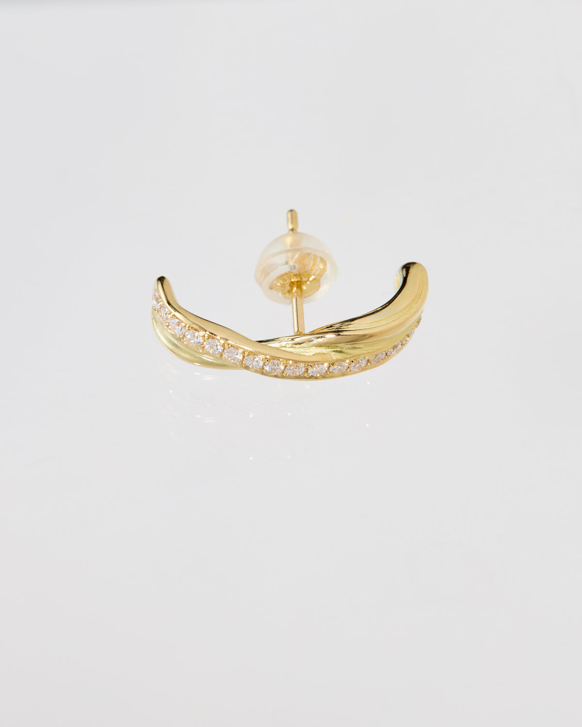 A gold huggie stud earring with a row of small pavé diamonds along the front curve, shown on a clean white background.