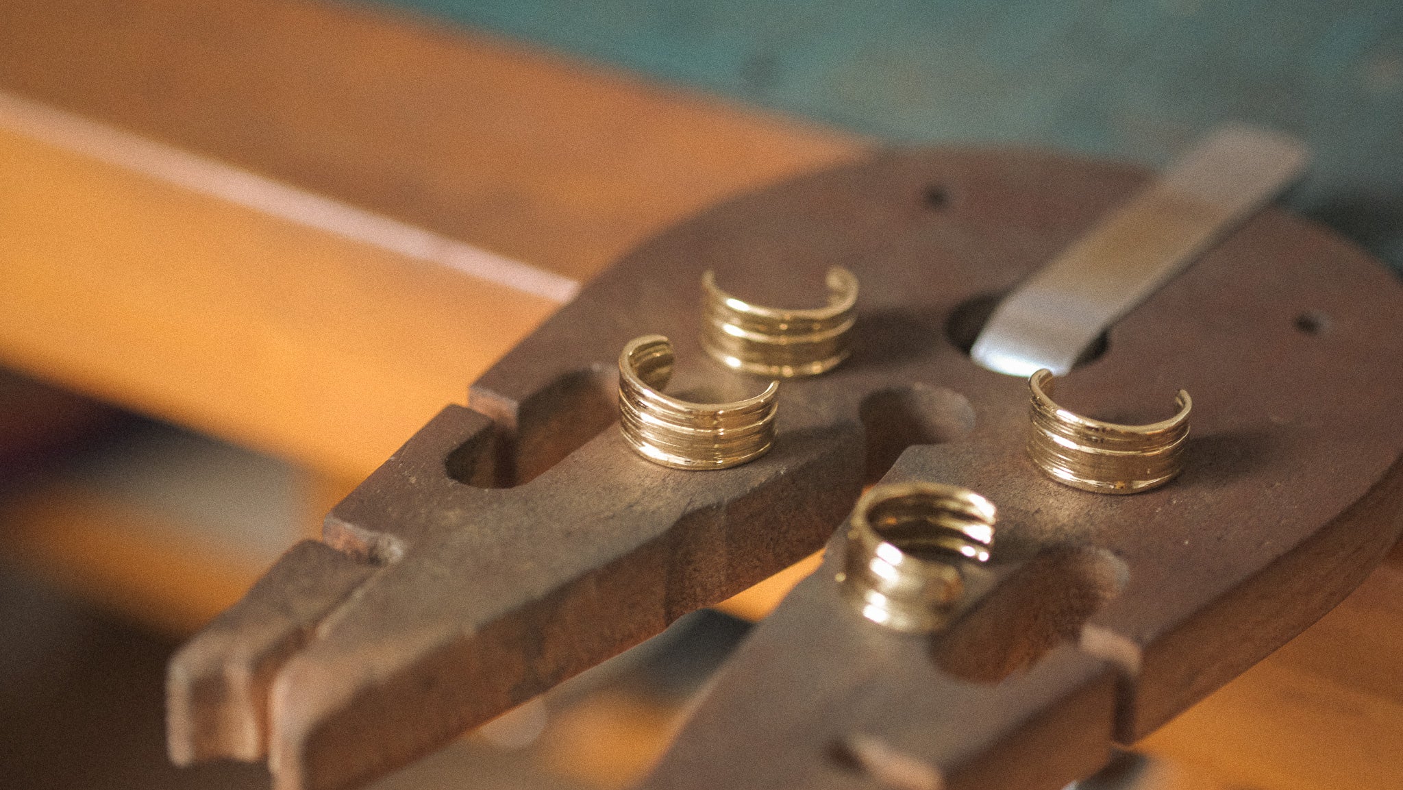 Two pairs of the Komorebi Hoops in progress on a jeweler's bench