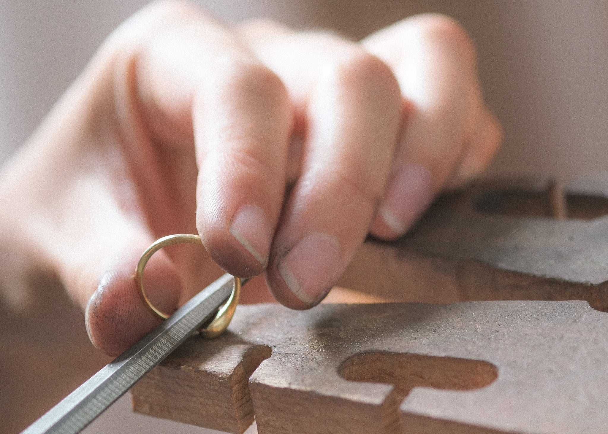 Anne Hara shaping a gold ring in her studio