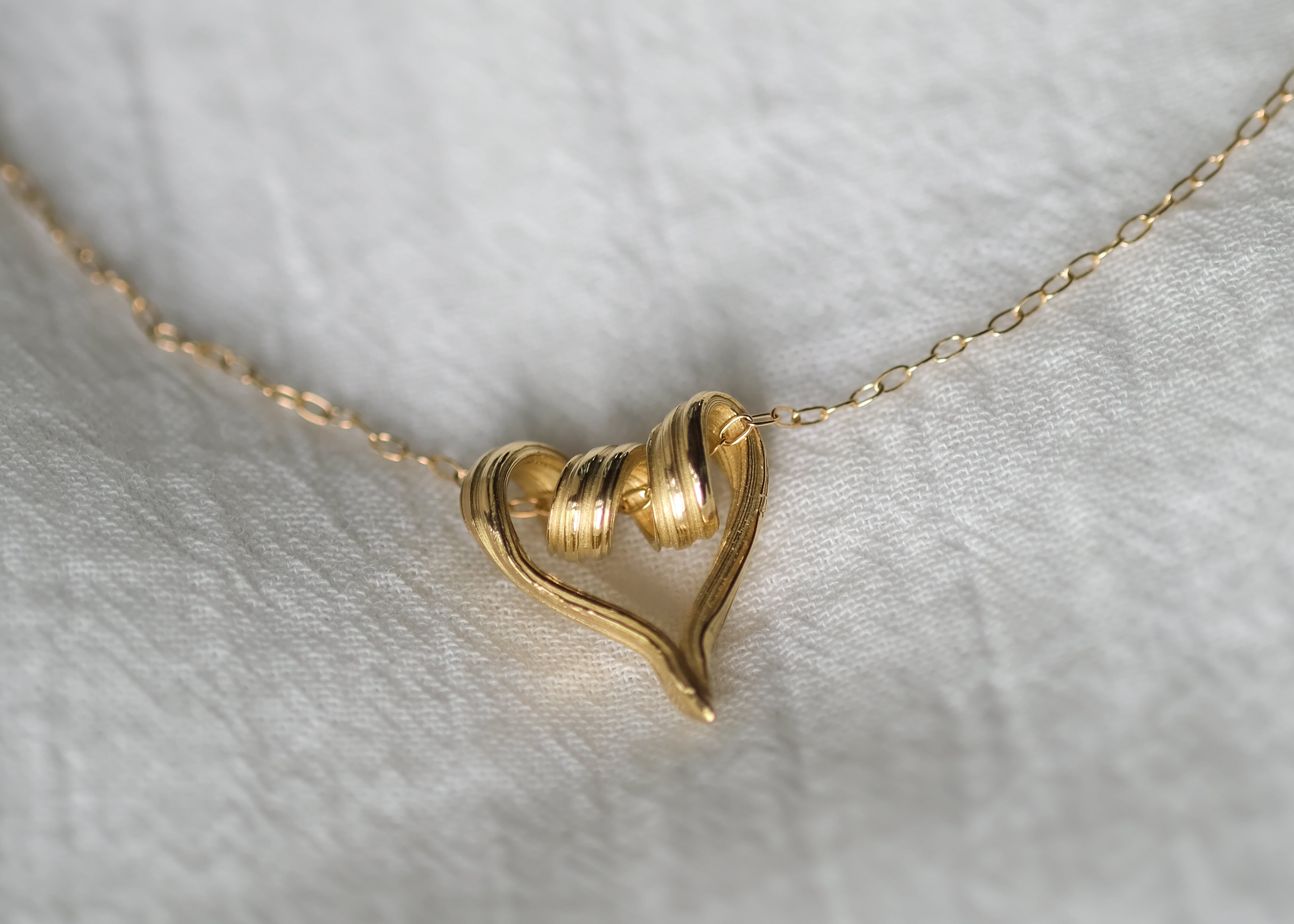 One-of-a-kind textured heart pendant in yellow gold