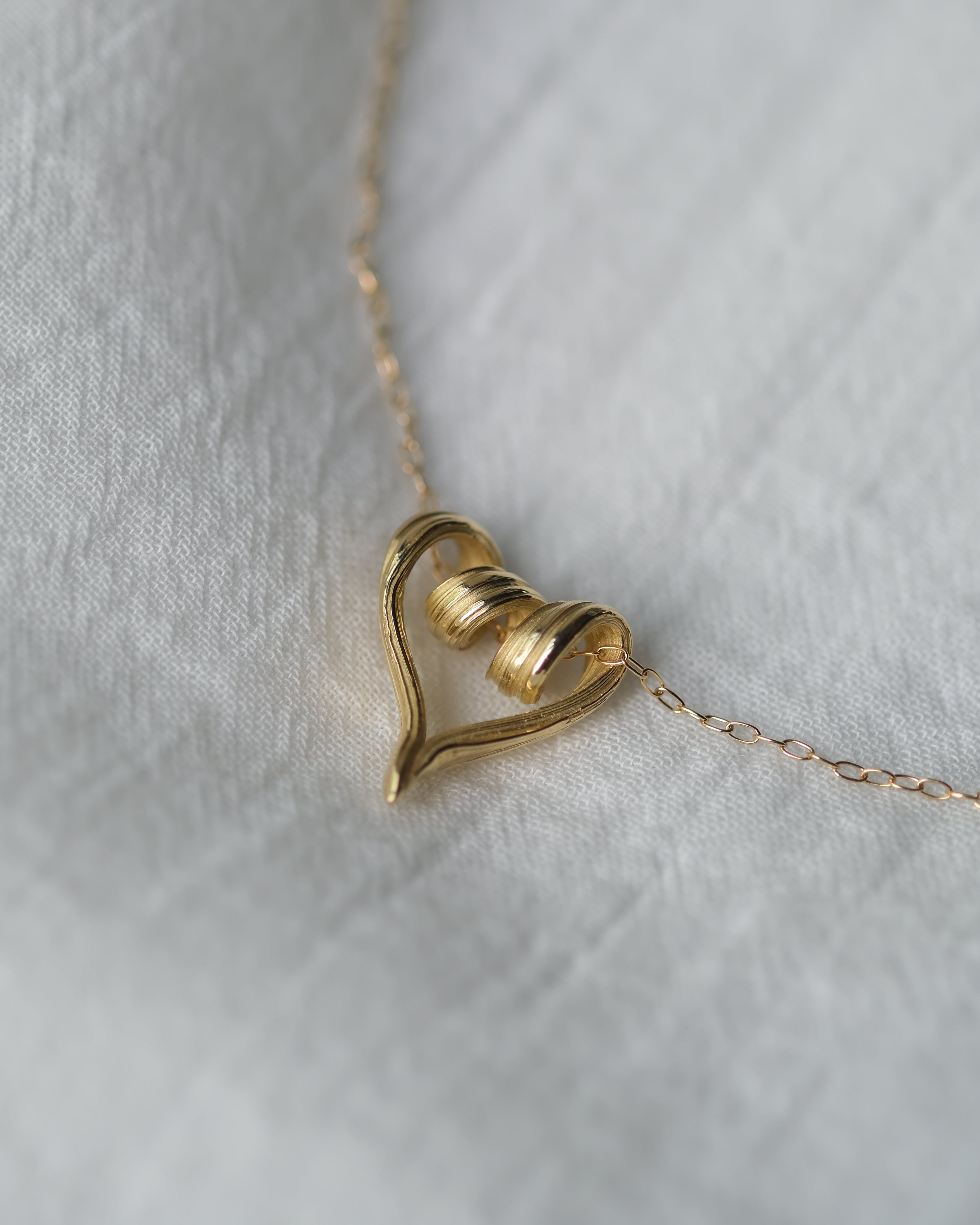 One-of-a-kind textured heart pendant in yellow gold