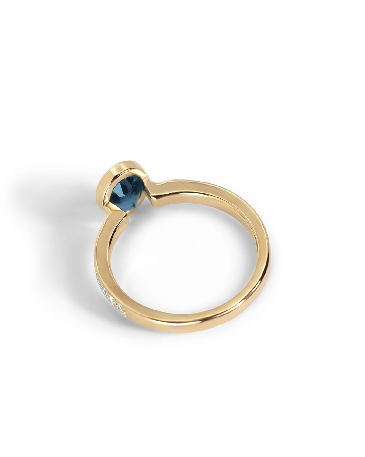 Back view of the 1.51ct Montana sapphire ring, showing the open bezel that lets light through the stone.