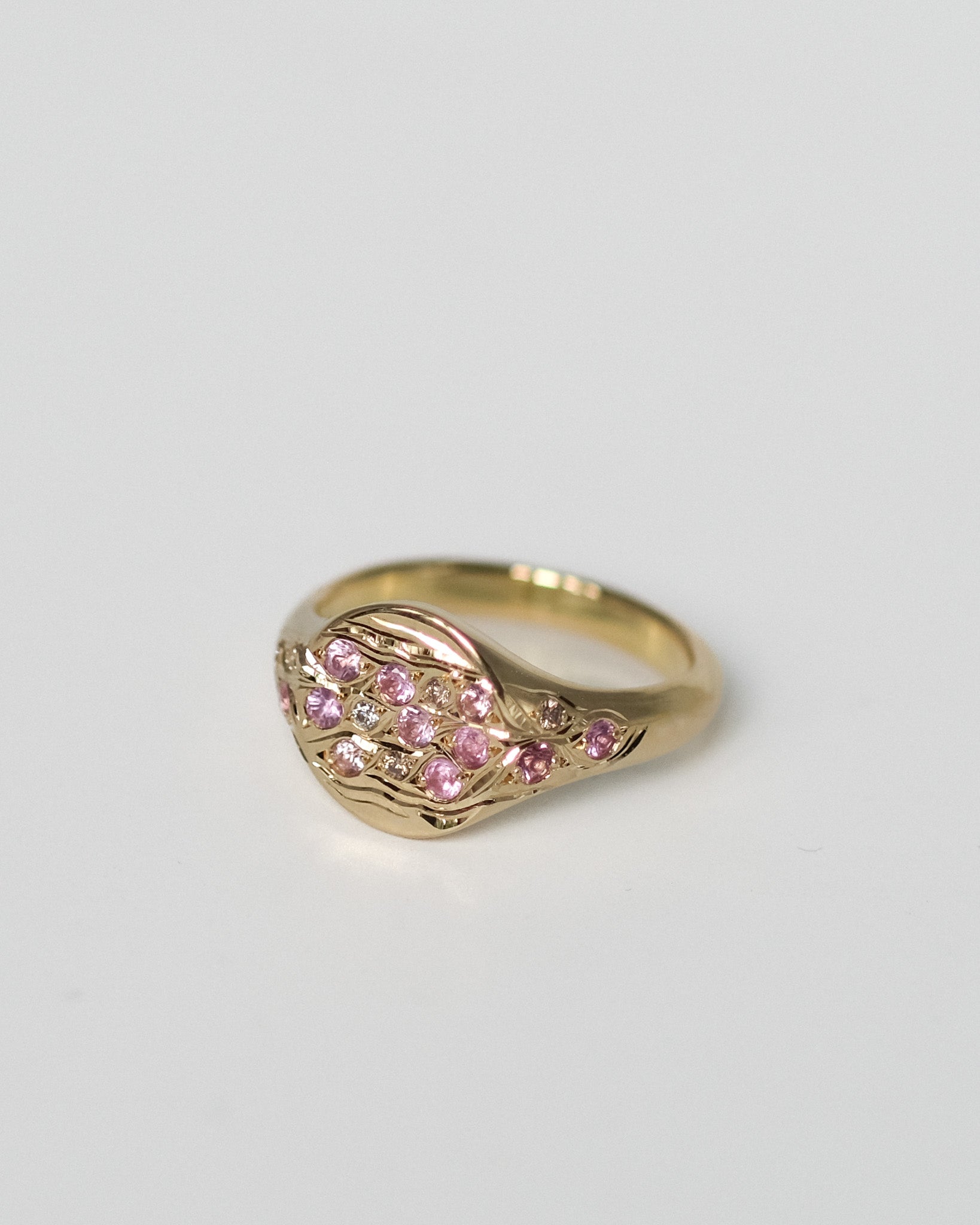 Hand set and engraved pinky signet ring with pink natural sapphires, champagnes and white diamonds.