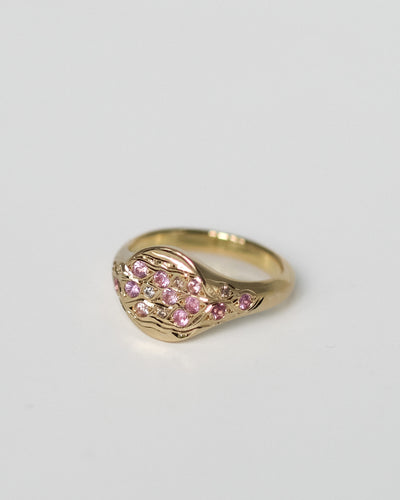 Fallen Petals Pinky Ring turning in the light, hand-set pink sapphires and champagne diamonds on engraved 18k gold.